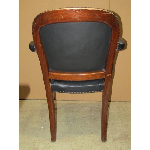 2249 - A Georgian style open armchair with dark leather upholstered seat, arched back and arm rests with st... 