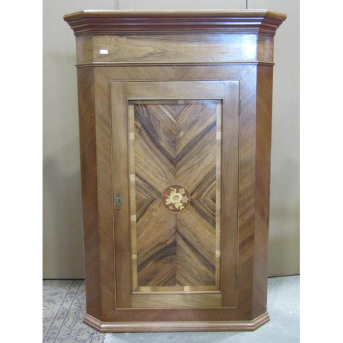 2245 - A Georgian style pale walnut and rosewood veneered hanging corner cupboard, enclosed by a rectangula... 