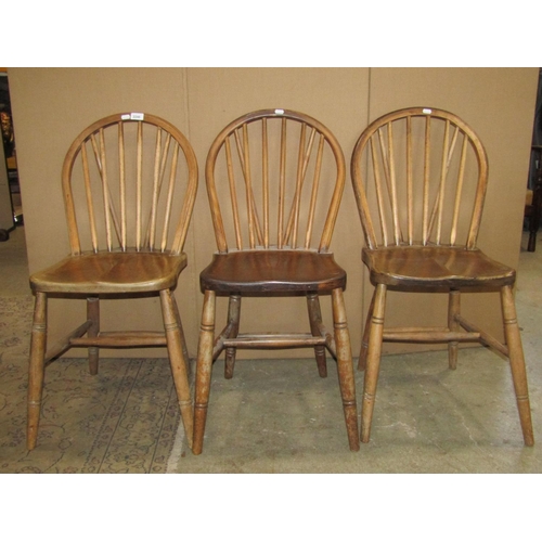 2246 - A set of six Windsor stained elm and beechwood hoop and stick back dining chairs with saddle shaped ... 