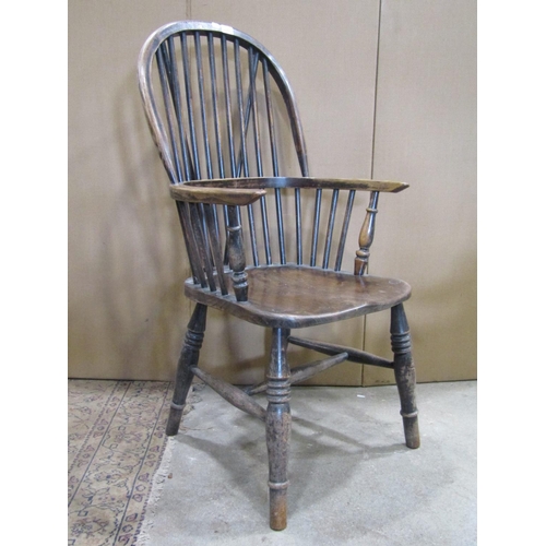 2247 - A Windsor stained ash and elm hoop and stick back elbow chair with saddle shaped seat raised on ring... 