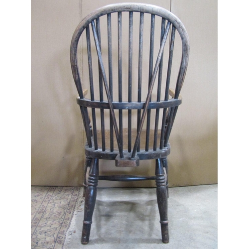 2247 - A Windsor stained ash and elm hoop and stick back elbow chair with saddle shaped seat raised on ring... 