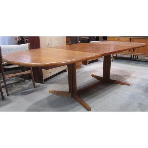 2260 - A Danish teak D end pull out extending dining table with moulded outline and single additional leaf ... 