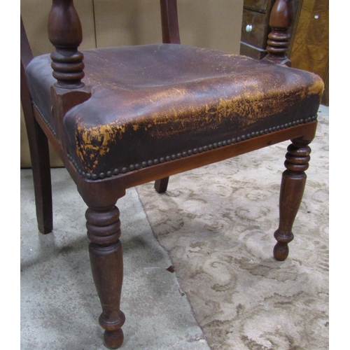 2280 - A late Victorian mahogany open elbow chair with moulded bar back over a worn leather upholstered sea... 