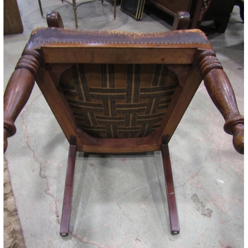 2280 - A late Victorian mahogany open elbow chair with moulded bar back over a worn leather upholstered sea... 