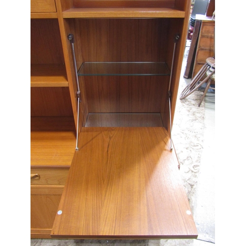 2304 - A G plan teak floorstanding wall unit in two sections enclosed by an arrangement of cupboards and dr... 