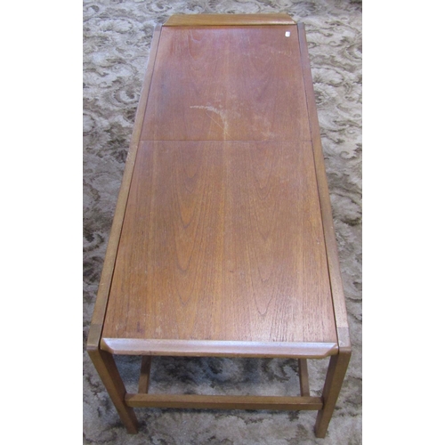 2305 - A retro teak low occasional table of rectangular form, the top with draw-leaves revealing a Formica ... 