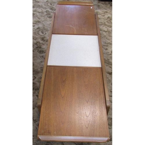 2305 - A retro teak low occasional table of rectangular form, the top with draw-leaves revealing a Formica ... 