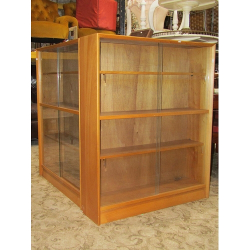 2306 - Three Herbert Gibbs pale teak freestanding library bookcases, each enclosed by two pairs of sliding ... 