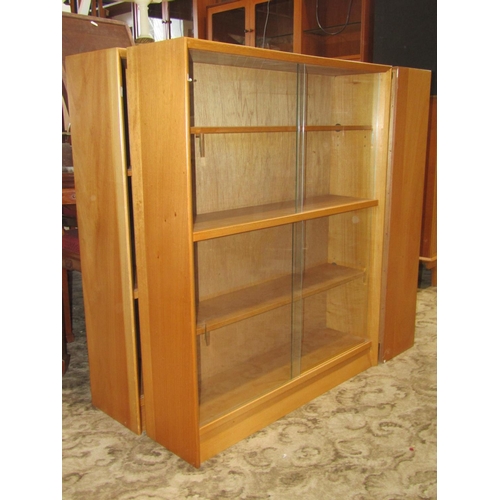 2306 - Three Herbert Gibbs pale teak freestanding library bookcases, each enclosed by two pairs of sliding ... 