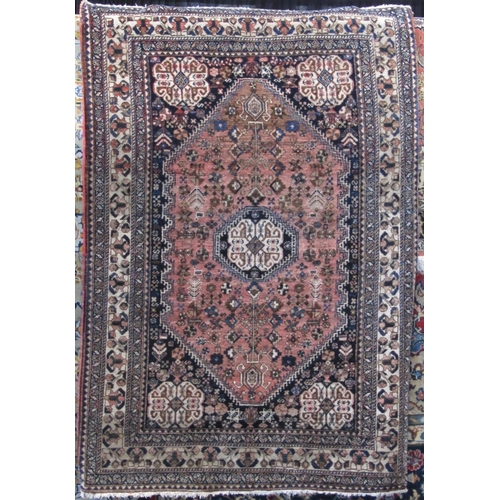 2466 - Good quality intricate rug of small proportions with various floral medallions upon a washed red and... 