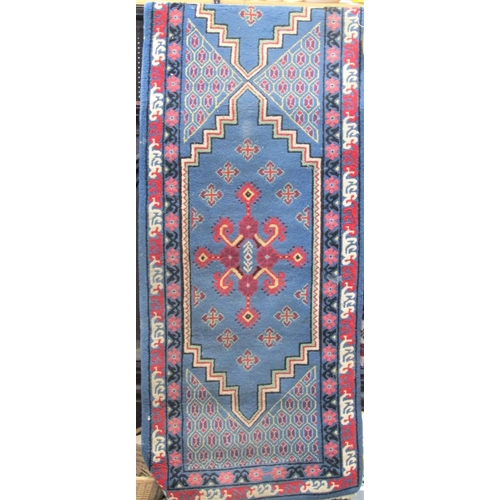 2456 - A Chinese full pile runner with red and colourful medallions upon a light blue ground, 320 x 80 cm