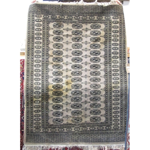 2468 - Bokhara rug with typical geometric decoration upon a washed ground, 180 x 130 cm