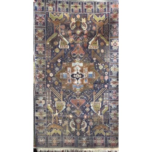 2472 - Old Baluchi type village rug with typical decoration upon a navy blue ground, 180 x 110 cm together ... 