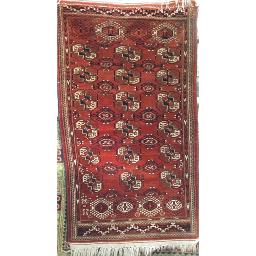 2473 - A good quality double handstitched Bokhara rug with typical geometric decoration upon a washed red/b... 