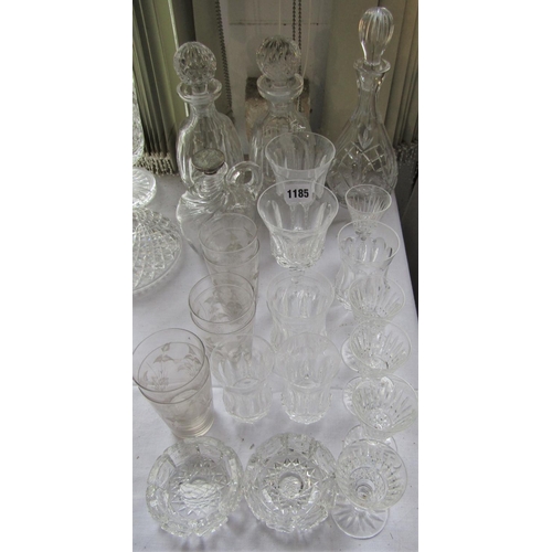 1185 - A collection of probably mainly Waterford crystal glassware comprising three decanters, a collection... 