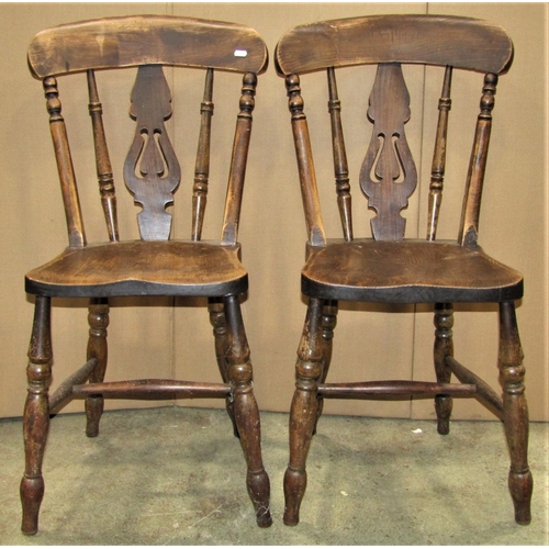 2329 - A 19th century elm and beechwood smokers bow elbow chair with turned spindle back over a saddle shap... 