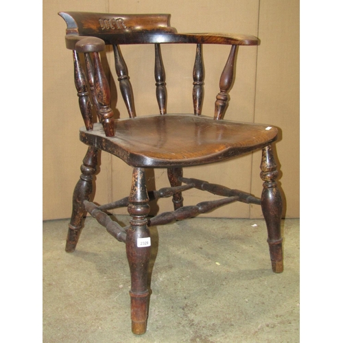 2329 - A 19th century elm and beechwood smokers bow elbow chair with turned spindle back over a saddle shap... 