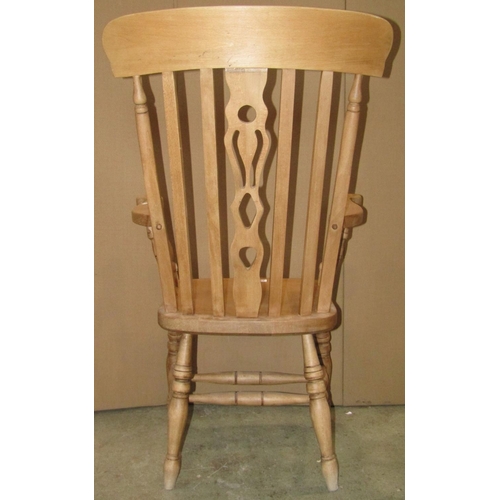 2332 - A modern reproduction beechwood Windsor lathe back armchair with central pierced splat