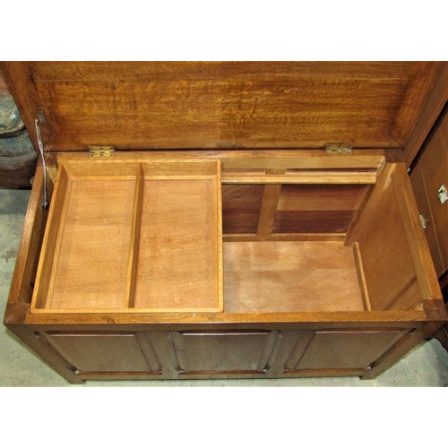 2341 - An oak blanket box with hinged lid and panelled frame and removable sliding two divisional sliding c... 