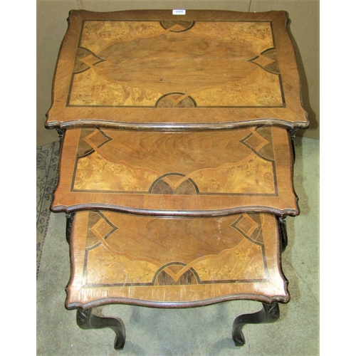 2371 - A nest of three tall graduated walnut veneered occasional tables, the rectangular tops with serpenti... 