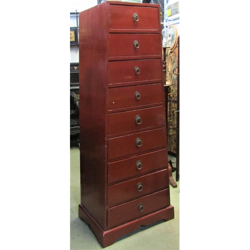 2373 - A crimson lacquered pedestal chest of tapered form fitted with nine drawers and set on a moulded pli... 