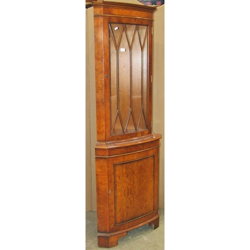 2379 - A reproduction Georgian style figured and burr walnut veneered bow fronted free standing corner cabi... 