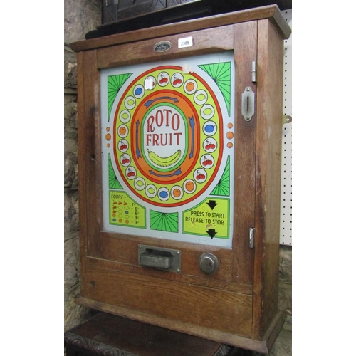 2385 - A vintage 'Roto Fruit' wall mounted oak framed fruit machine cabinet, enclosed by a glazed panelled ... 