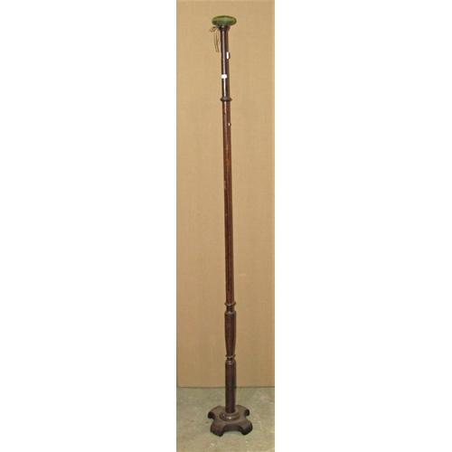 2391 - An Edwardian oak wig stand with slender turned and fluted stem, raised on a shaped platform base, 16... 