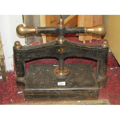 2111 - A small but heavy cast iron book/paper press, with central screw thread, brass or possibly bronze fi... 