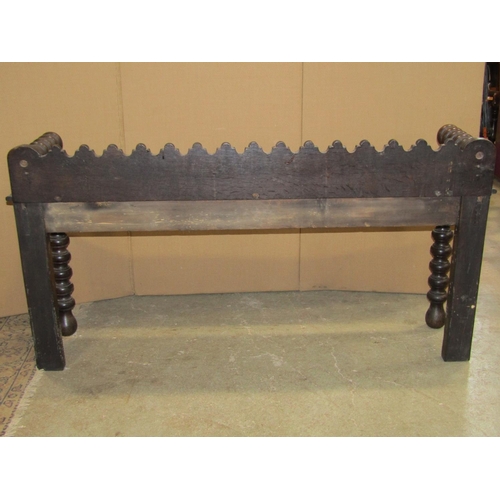 2395 - A late Victorian oak hall bench with repeating carved foliate detail, bobbin turnings and Gothic tra... 