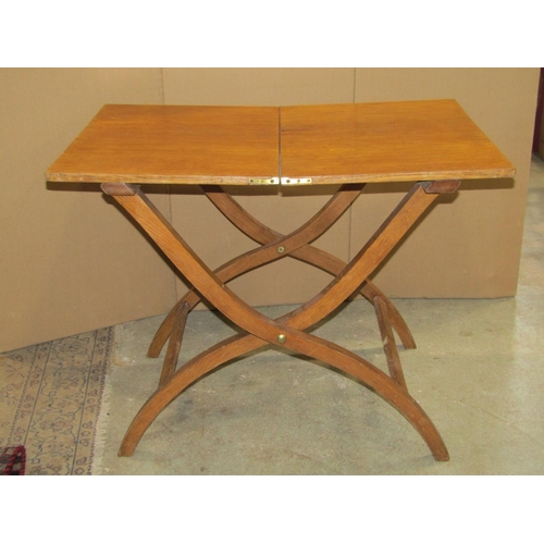 2398 - A medium oak X framed folding campaign or coaching type table of rectangular form