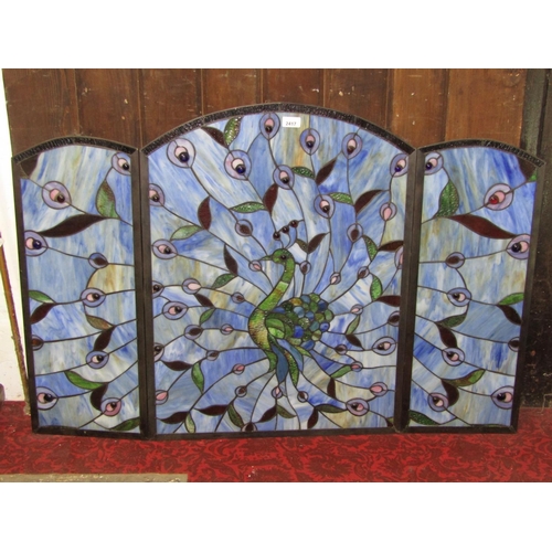 2417 - A stained glass three fold screen, study of a peacock and radiating feathers, 77cm high x 114cm wide