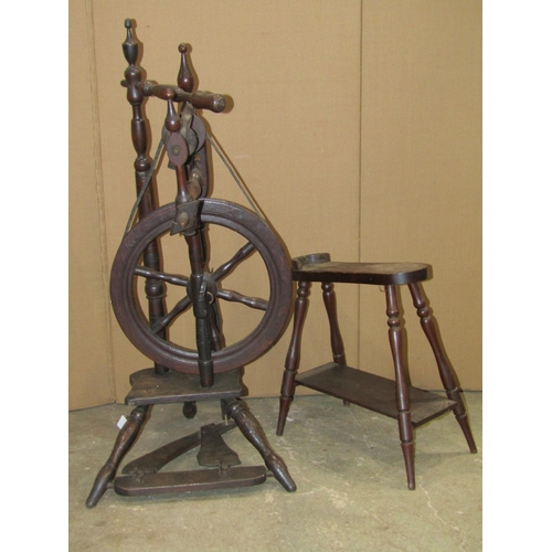 2420 - An antique foot pedal operated spinning wheel with turned frame, spoke wheel and splayed tripod supp... 