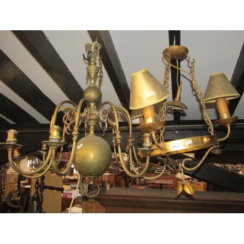 2425 - An ironwork hanging ceiling light with gilt finish, the circular ring supporting three branches/scon... 