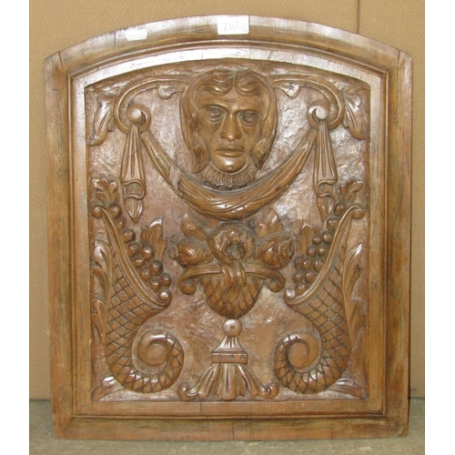 2112c - Antique walnut panel of arched form, carved with a mask over garlands, cornucopia and bowls of fruit... 