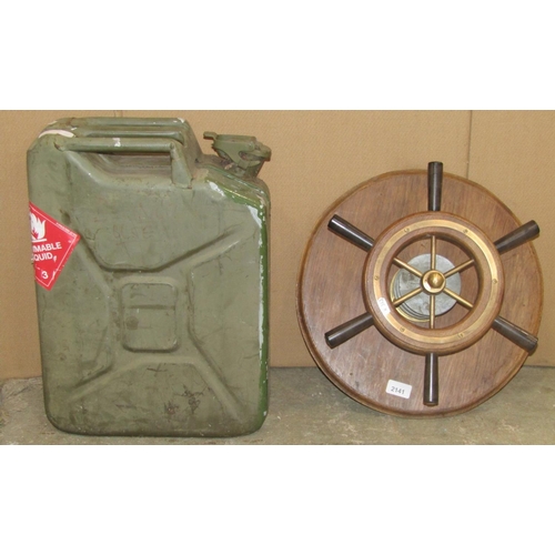 2141 - A small ships wheel with cast metal fittings, mounted on a circular board, together with a jerry can... 