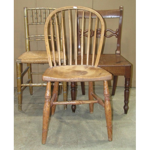 2253 - A Windsor stained elm and beechwood spindle back open armchair with saddle shaped seat raised on spl... 