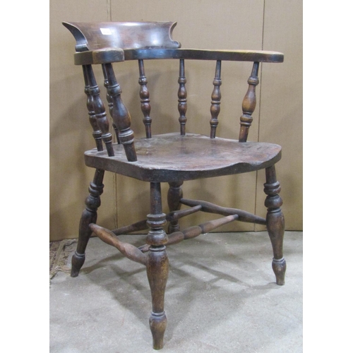 2334 - A 19th century elm and beechwood smokers bow arm chair