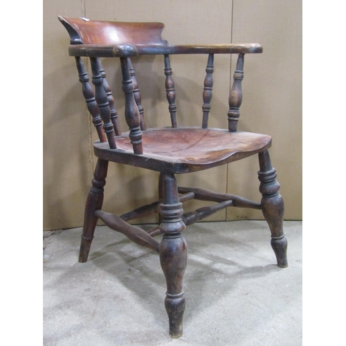 2335 - A 19th century mixed wood smokers bow arm chair