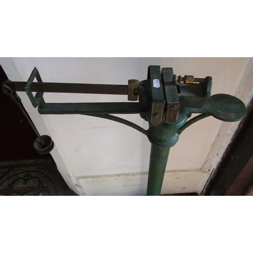 2105 - An antique cast iron platform scale, with brass fittings and original green painted and gilt highlig... 