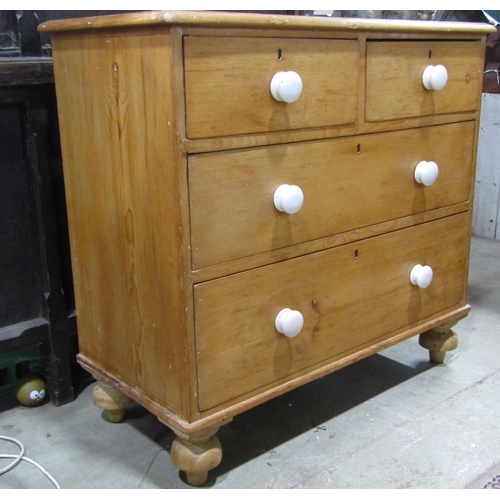 2119 - A small Victorian stripped pine bedroom chest of two short over two long graduated drawers, raised o... 