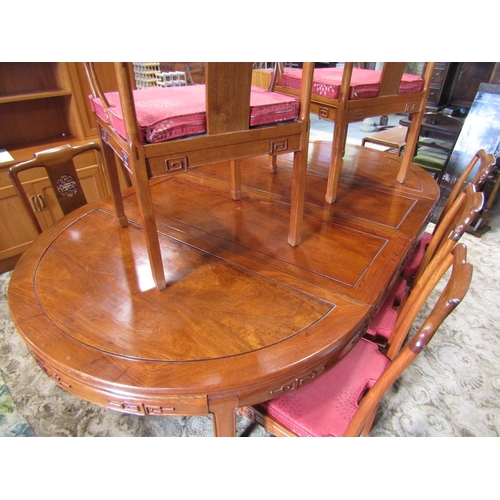 2312 - A Chinese hardwood D end extending dining table, the panelled top with two additional leaves raised ... 