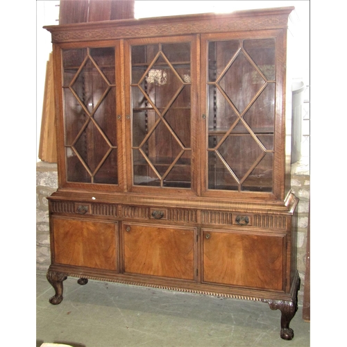 2339 - A good quality two sectional side cabinet in walnut, the upper with blind fret frieze over three ast... 