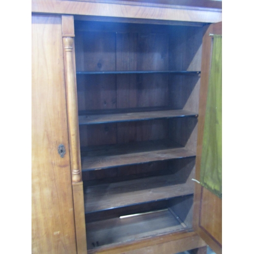 2344 - A 19th century continental fruitwood side cupboard enclosed by three full length doors, the central ... 