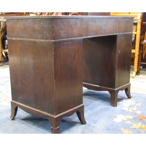 2353 - A Georgian style kneehole three sectional twin pedestal desk with serpentine front and inset leather... 