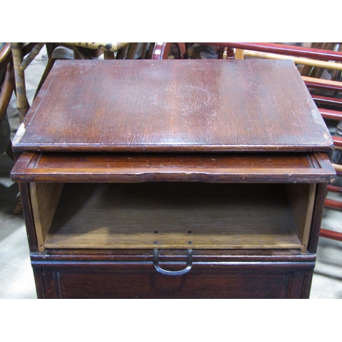 2357 - A vintage oak veneered floorstanding filing cabinet enclosed by four up and over rectangular panelle... 