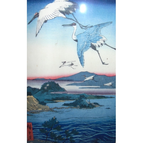 271 - Two Japanese wood block coloured prints, one of an eagle soaring over a lake, the other of cranes fl... 