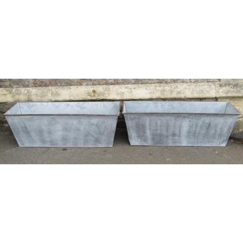 2069A - A pair of Heritage galvanised tin planters of rectangular tapered form 105cm long x 35cm wide x 36cm... 