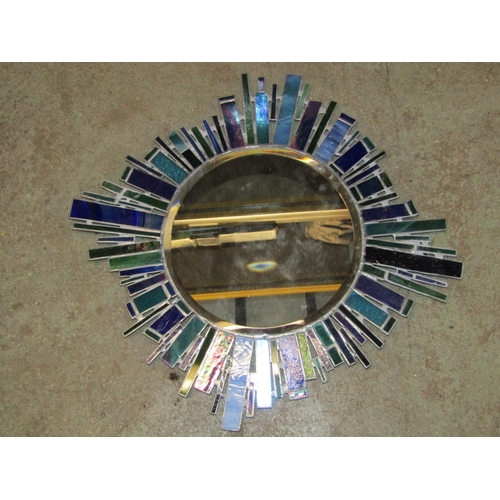 2130 - A contemporary fusion moulded glass wall mirror of square form, with decorative sunburst, lighthouse... 