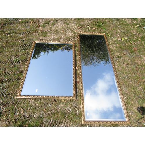 2405 - Two similar contemporary gilt framed wall mirrors of rectangular form, with repeating scrolling acan... 